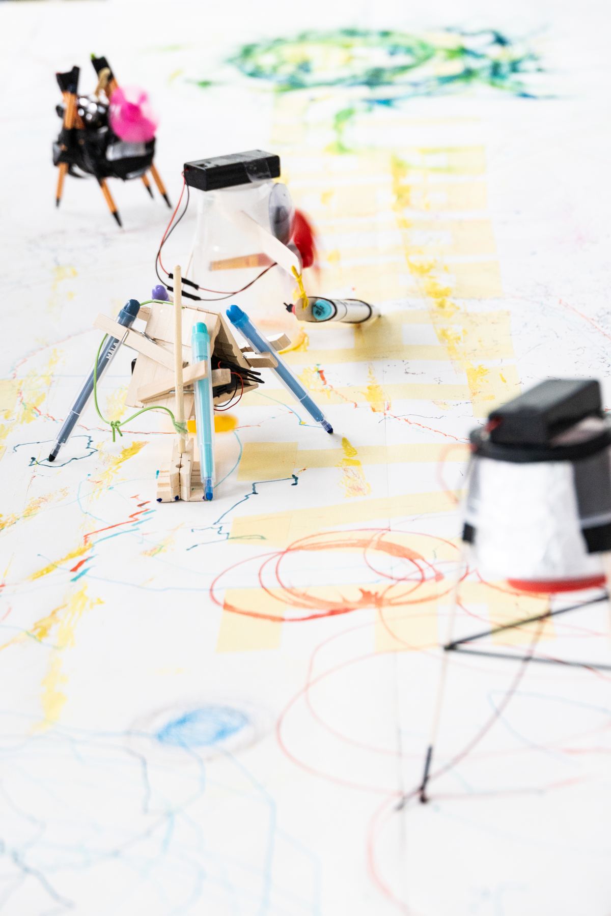 Several pen-legged robots on the shared paper