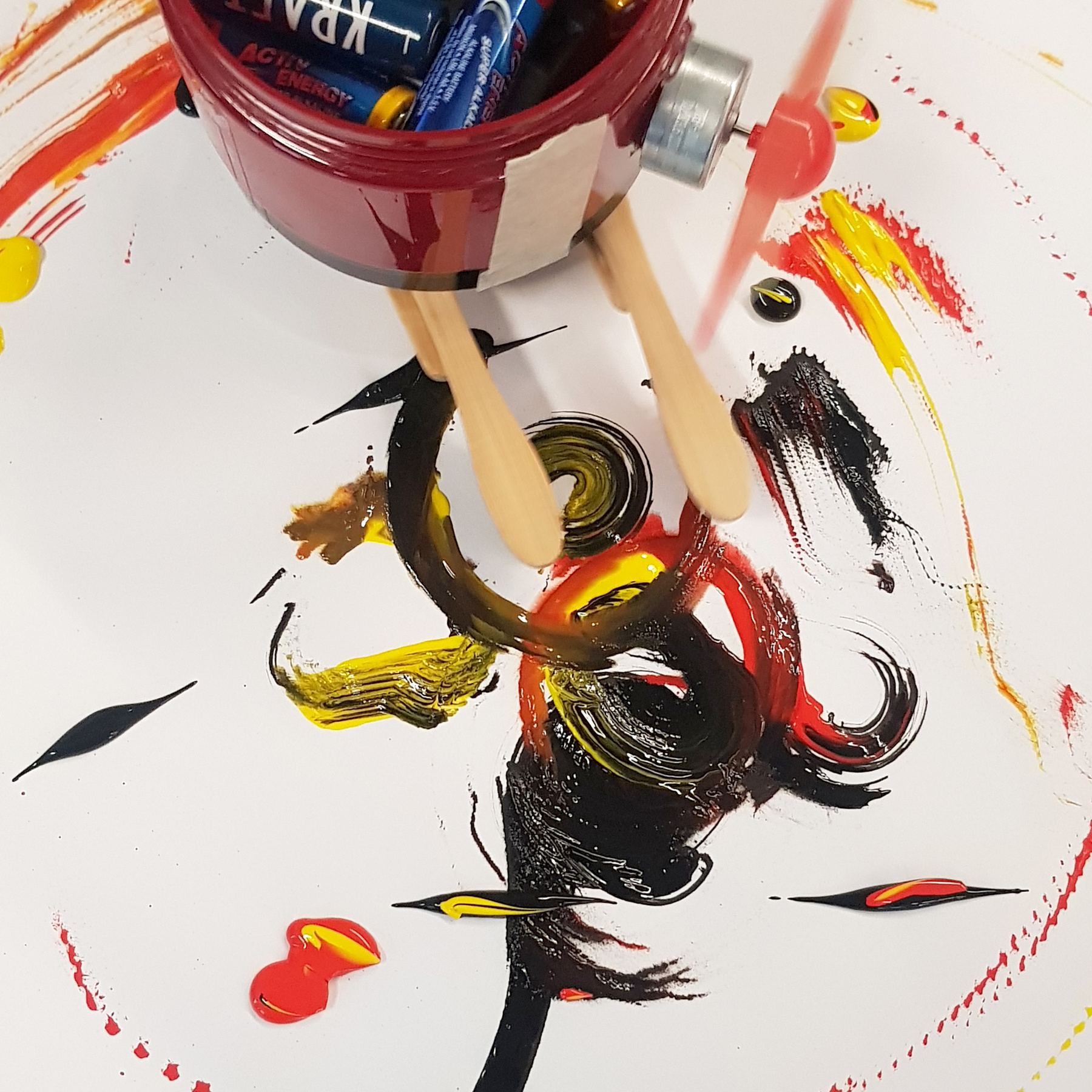 Close-up of black, red and yellow paint strokes under the robot