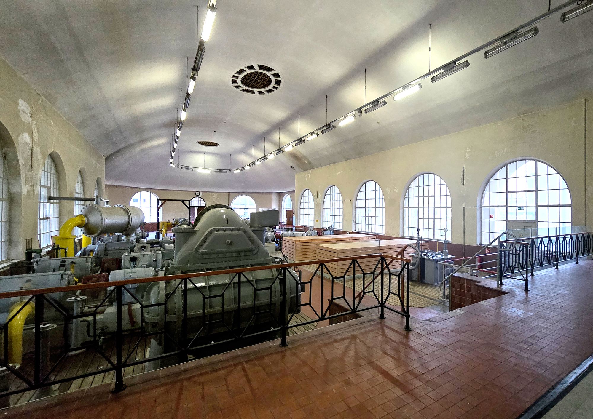 Historic machine hall of the Augsburg gasworks with arched windows and old engines