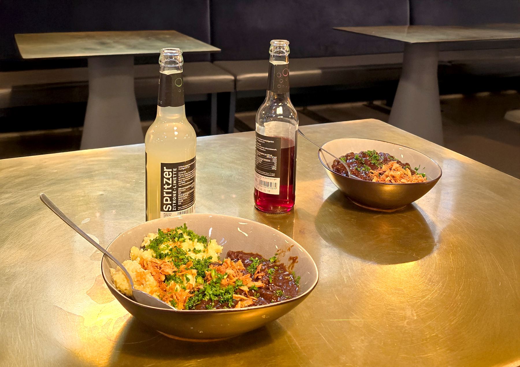 Two bowls of food and drinks on a table