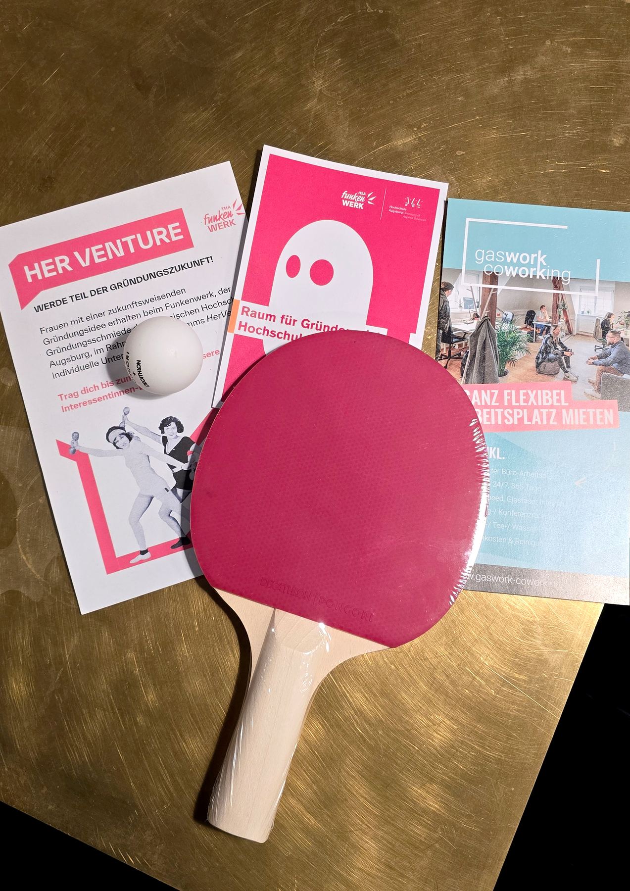 Table-tennis paddle and ball on top of three flyers