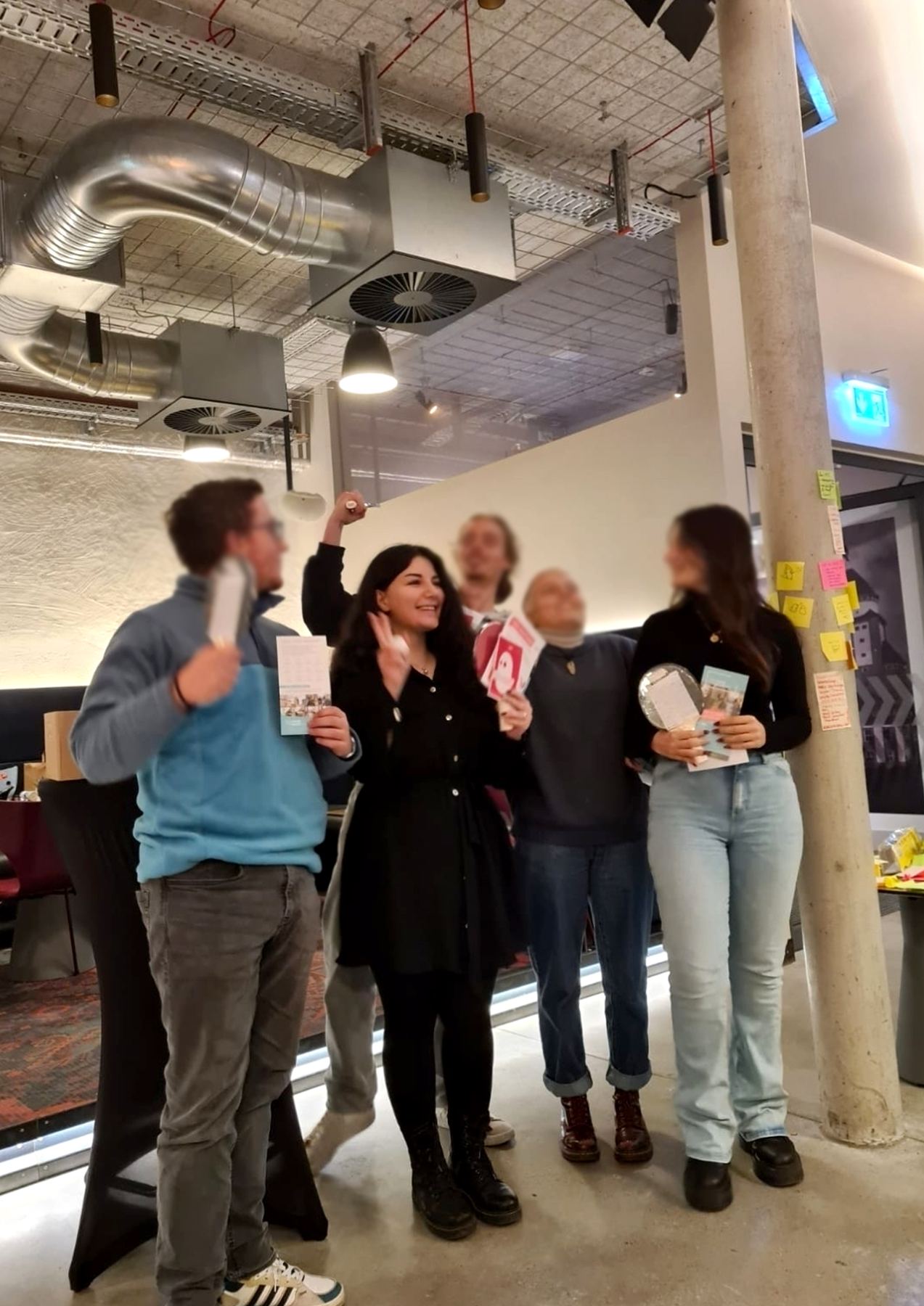 The five team members celebrating with the souvenir