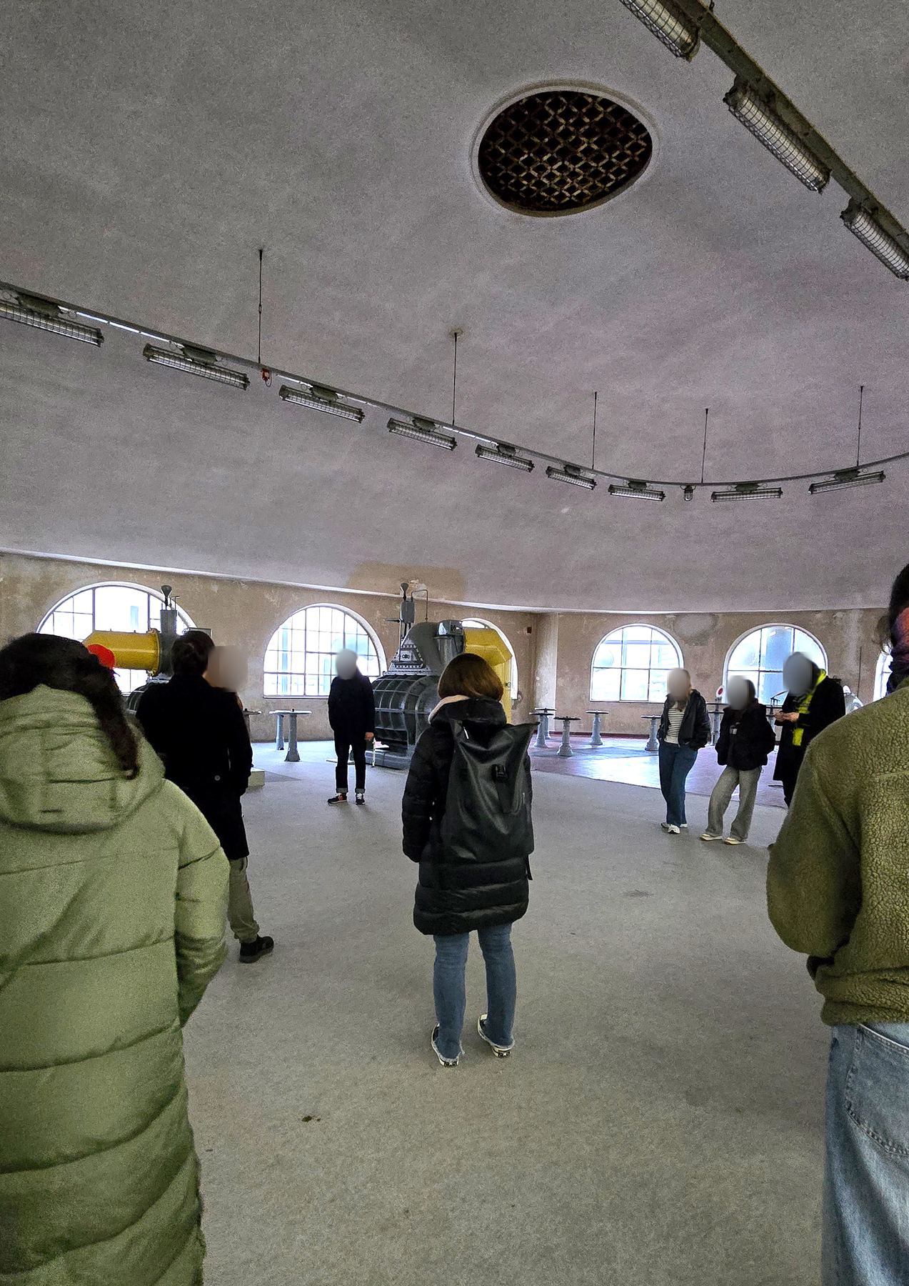 Participants standing in a round historic hall of the gasworks
